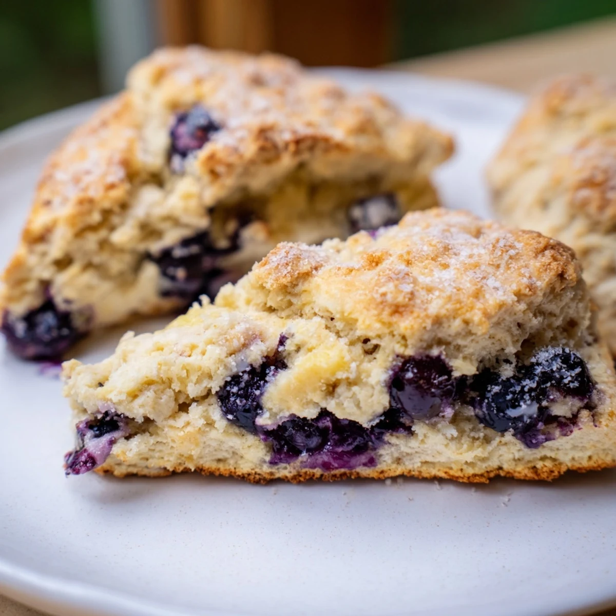 Warm, golden Rustic Birch-Warm Blueberry Scones, bursting with plump, juicy blueberries, ready to eat.