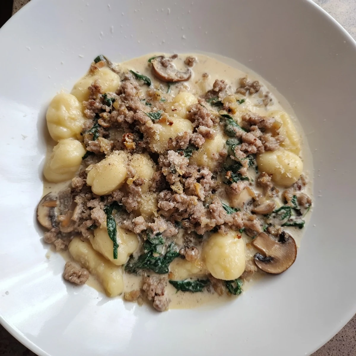 Golden brown sausage and tender gnocchi highlight this Woodsy Skillet Sausage and Mushroom Gnocchi dinner recipe.