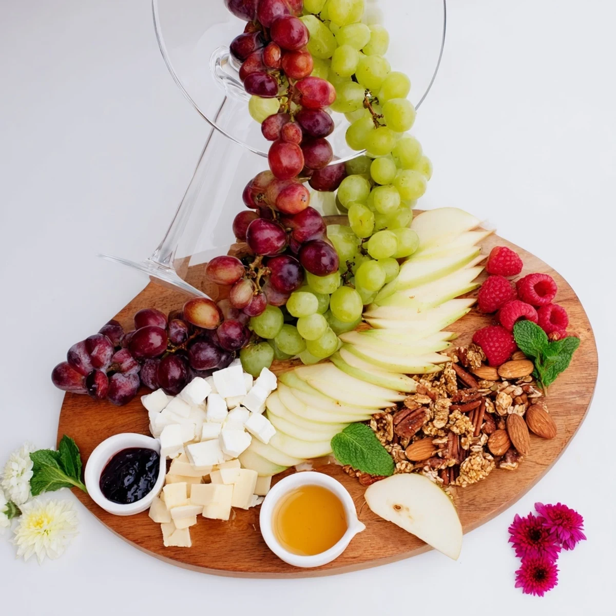 Visually stunning Champagne Waterfall Board, featuring cascading fruit and cheeses, perfect for celebrations.