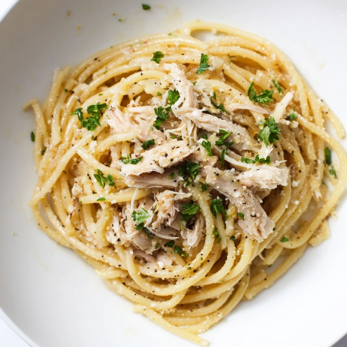 A close-up of Simple Garlic Butter Bucatini, perfectly twirled with tender shredded chicken.