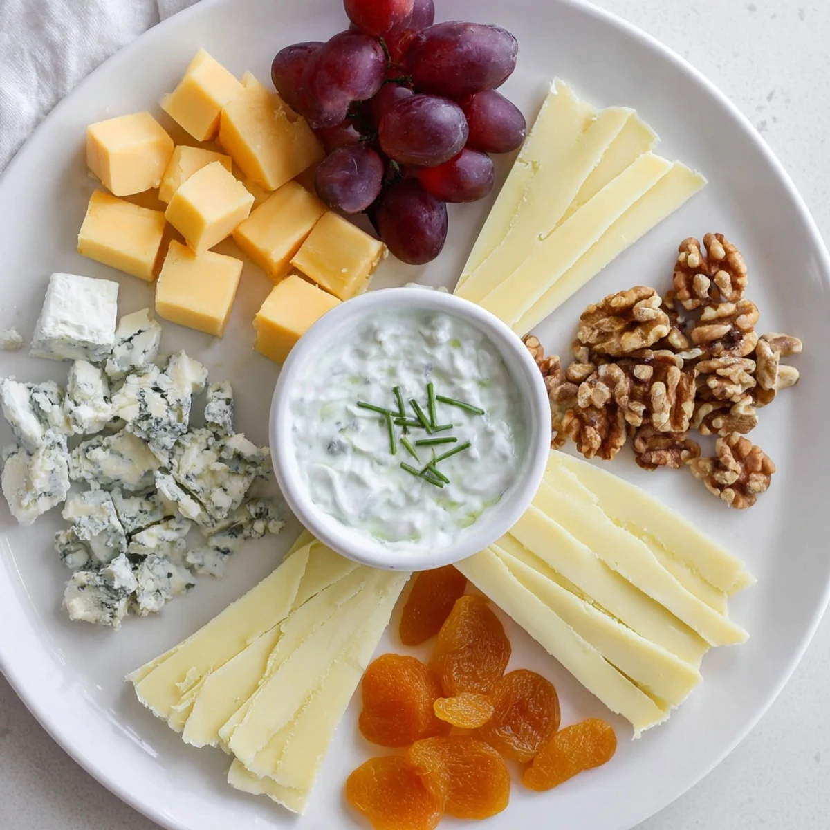 A beautifully arranged Celtic Cross Cheese Platter with creamy Brie and crumbled blue cheese.