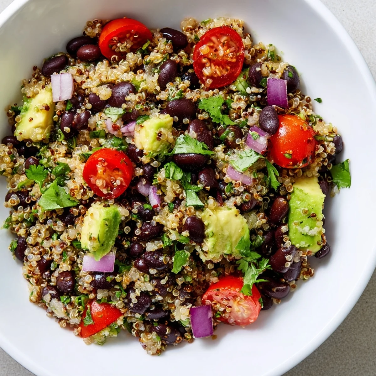 Vibrant quinoa black bean salad, featuring colorful veggies and a tangy lime dressing.