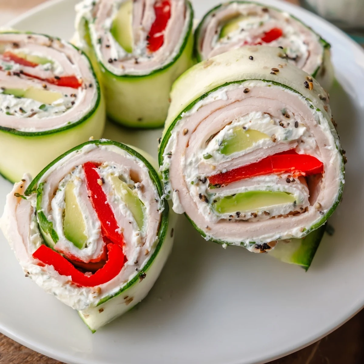 Cucumber Roll-Ups featuring vibrant deli meats and creamy filling, a refreshing low-carb snack.