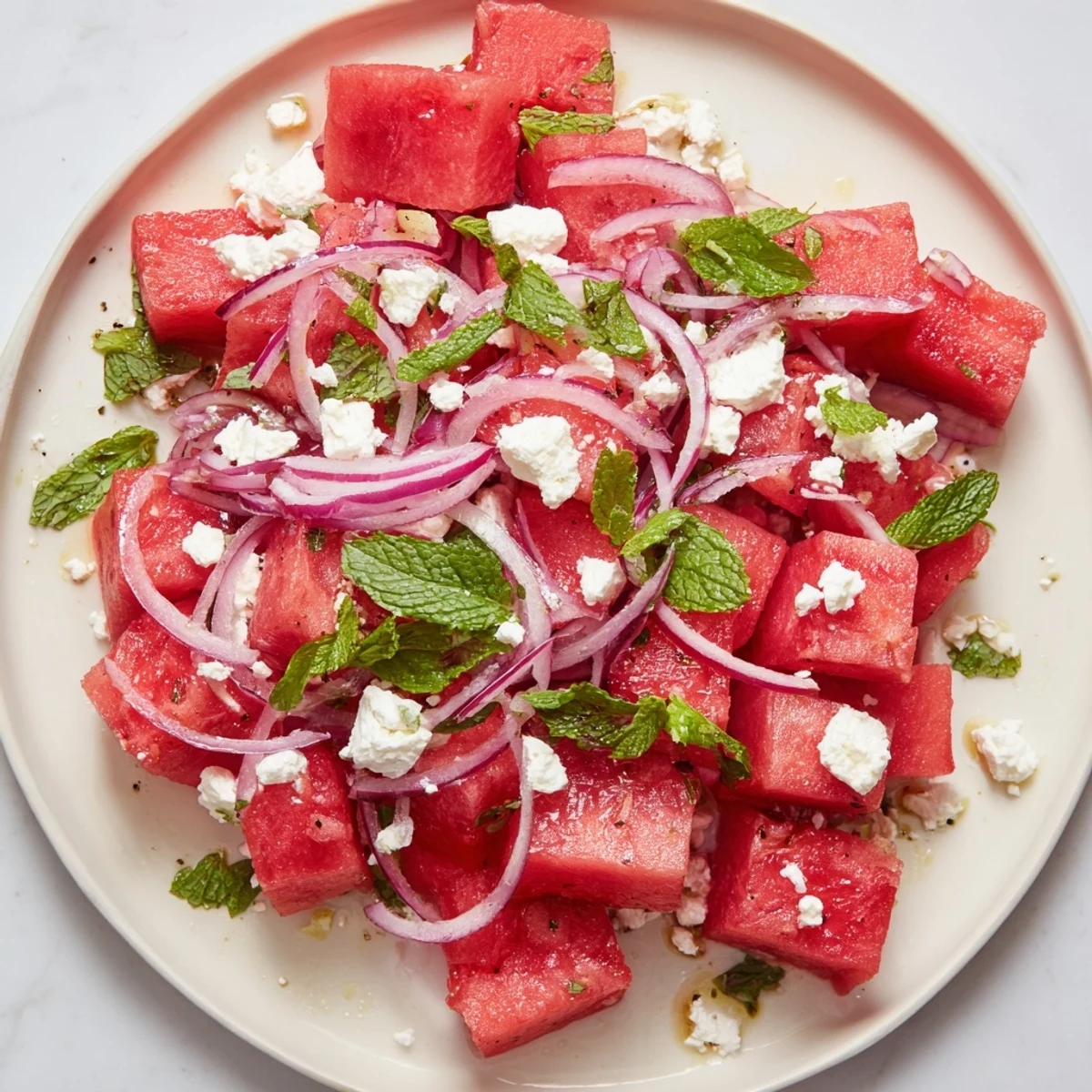 Close-up of a bowl overflowing with sweet watermelon, tangy feta, and a bright, zesty Watermelon Feta Salad.