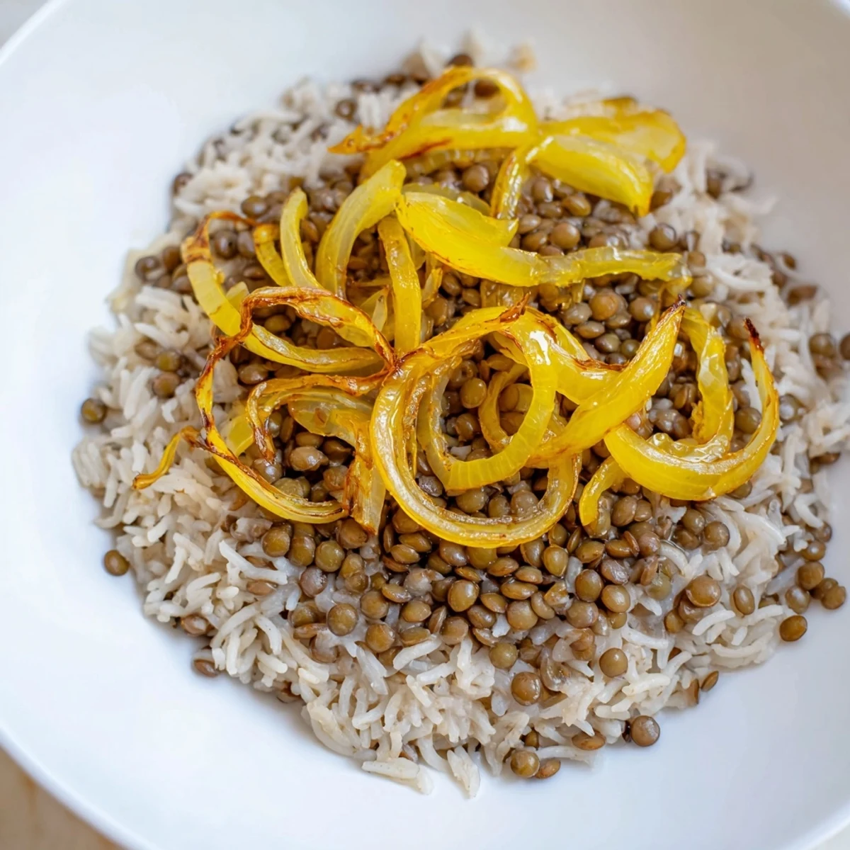 A close-up of fragrant Lebanese Mjadra, showing fluffy rice, tender lentils, and crispy onion topping.