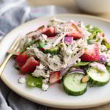 Colorful Strawberry Poppy Seed Chicken Salad served over mixed greens, topped with toasted almonds and optional crumbled feta for a light lunch. 