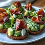 A colorful snack plate with green scrambled eggs, ham slices, and crackers inspired by a classic children's story.