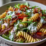 Fresh BLT Pasta Salad featuring ripe avocado, juicy cherry tomatoes, and crumbled bacon over tender pasta, drizzled with tangy dressing.  