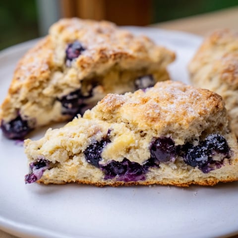 Warm, golden Rustic Birch-Warm Blueberry Scones, bursting with plump, juicy blueberries, ready to eat.