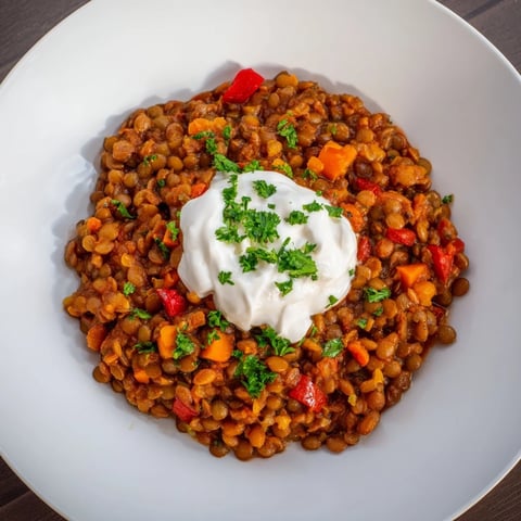 Bowl of warm Wheat-Warm Hearty Lentil Curry with fresh cilantro; ready to be served.