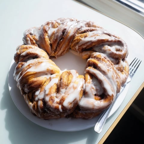 Warm and gooey cinnamon roll pull-apart wreath, fresh from the oven, ready to share with loved ones.