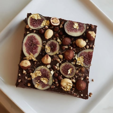 Midnight Mosaic dessert's mosaic top: dark figs, olives, chocolate, and hazelnuts, ready to slice.