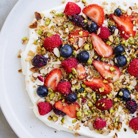 Vibrant photo displays chilled Frozen Fruit Yogurt Bark, ready to break, showcasing fresh berries and granola.