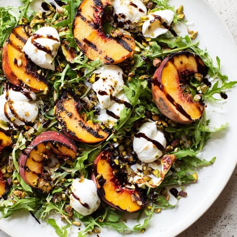 Grilled Peach Salad with charred peaches, creamy burrata, and fresh arugula, a perfect summer salad.