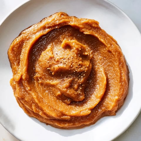 A warm Emirati Al Madrooba, a creamy breakfast spread made with dates and ghee, ready to eat.