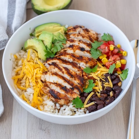 Sizzling grilled chicken, fluffy rice, and vibrant beans star in this hearty Spicy Chicken Burrito Bowl, topped with creamy avocado and zesty salsa.  