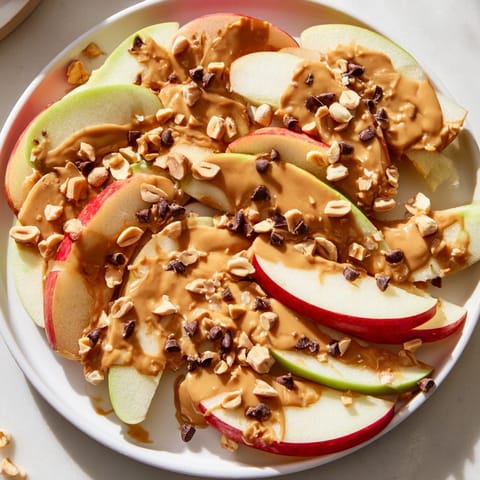 Sweet peanut butter and honey drizzled over fresh Apple Nachos, ready to enjoy as a snack.