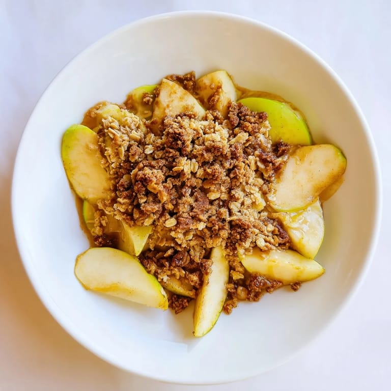 A close-up shot of the Warm Rustic Apple and Cinnamon Crumble, showcasing the buttery, crisp crumble.