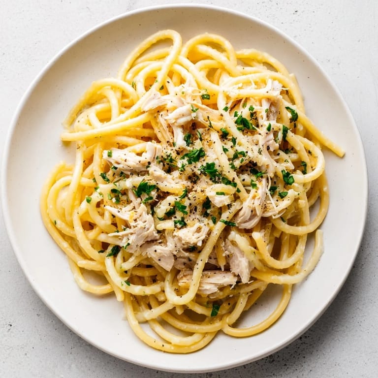 Enjoy a plate of creamy Simple Garlic Butter Bucatini with chicken, a quick weeknight dinner.
