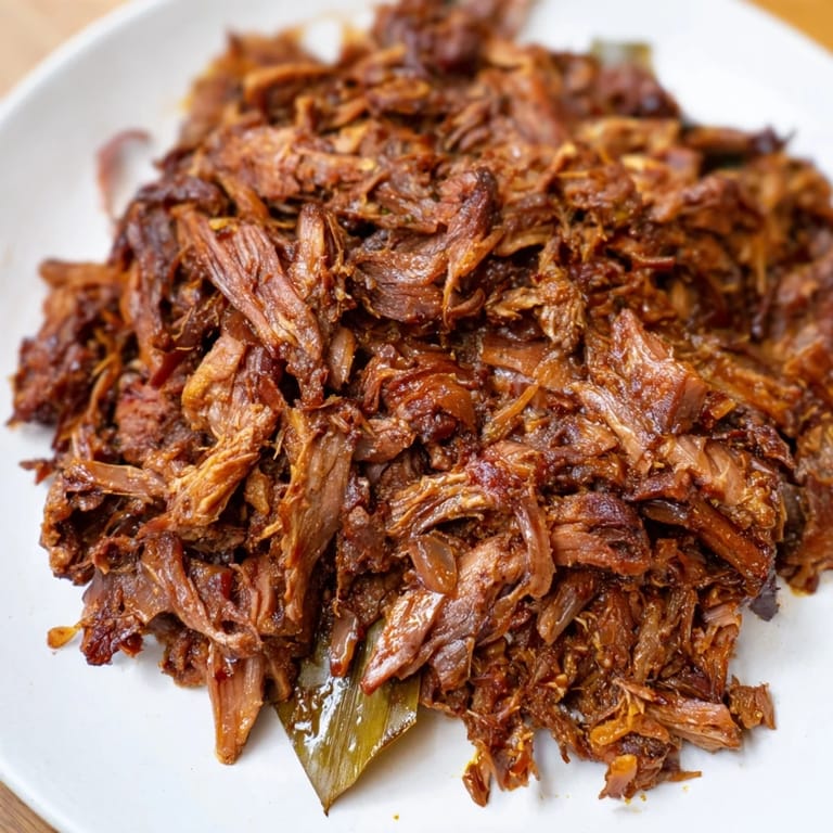 The finished Omani Shuwa dish presents wonderfully juicy, fall-apart meat after hours of slow roasting.