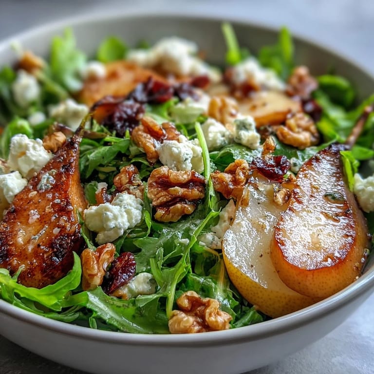 Vibrant Arugula and Pear Bowl served in a white bowl, ready to eat as a refreshing light lunch.