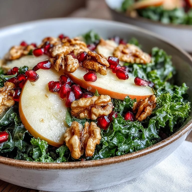 Crunchy walnuts and bright pomegranate arils top this massaged kale salad with sweet apple ribbons.